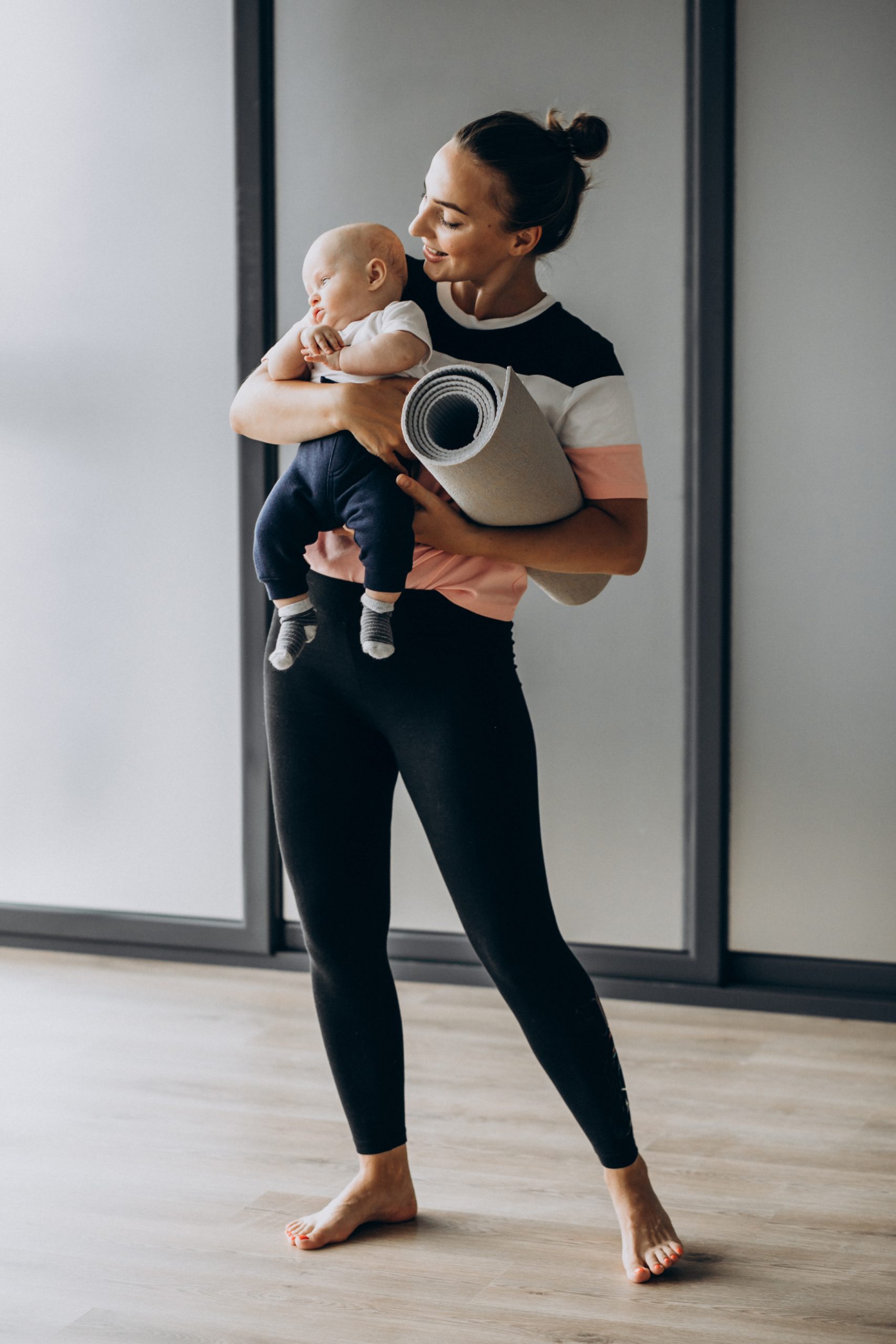 Mother with little baby boy practice yoga